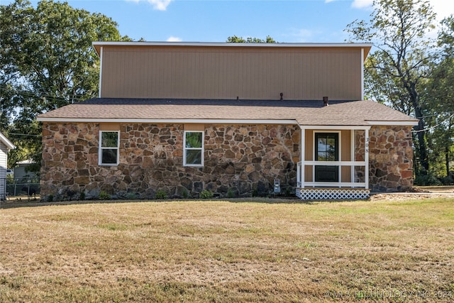 back of property featuring a yard