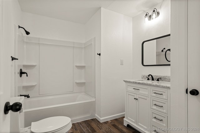 full bathroom featuring shower / bathing tub combination, hardwood / wood-style floors, vanity, and toilet