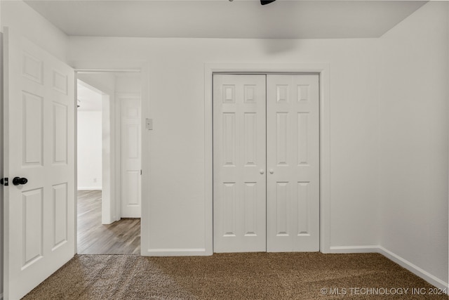 unfurnished bedroom with carpet flooring and a closet