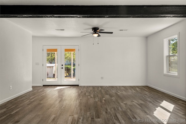 spare room with beamed ceiling, french doors, dark hardwood / wood-style flooring, and a wealth of natural light