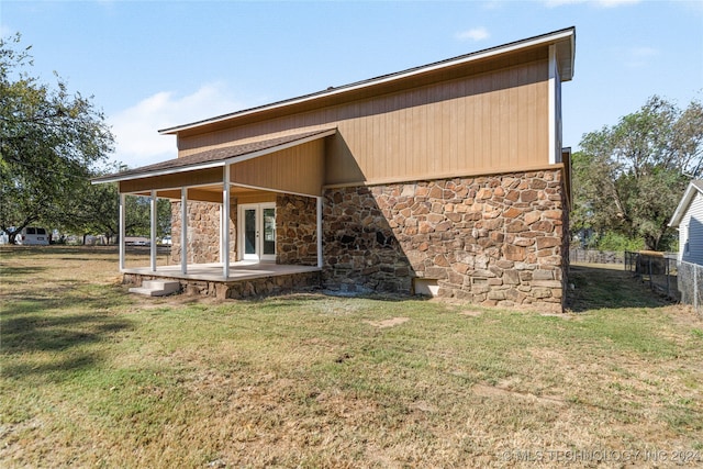 back of house with a yard and a patio area