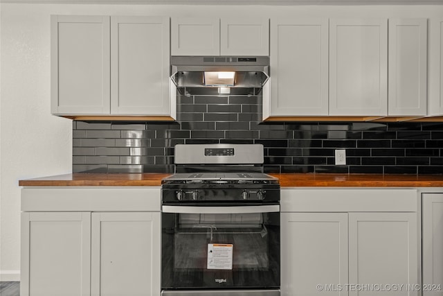 kitchen with wood counters, decorative backsplash, extractor fan, white cabinetry, and stainless steel range with gas stovetop