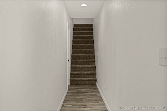 stairs featuring hardwood / wood-style floors