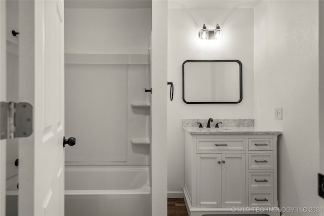 bathroom featuring shower / tub combination, vanity, and hardwood / wood-style flooring