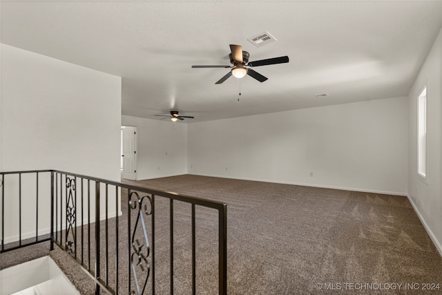 empty room with carpet flooring and ceiling fan