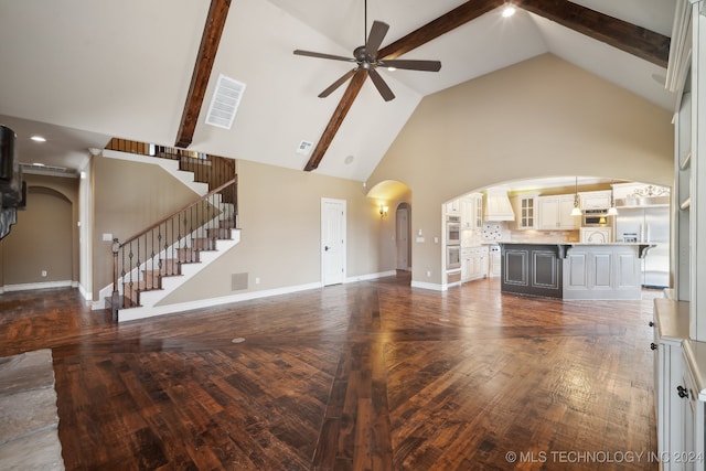 unfurnished living room featuring dark hardwood / wood-style floors, ceiling fan, beamed ceiling, and high vaulted ceiling