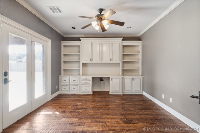 unfurnished office featuring built in desk, ceiling fan, dark wood-type flooring, and crown molding