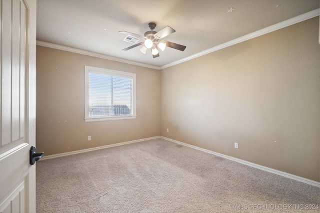 carpeted spare room featuring ceiling fan and crown molding