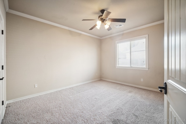 carpeted spare room featuring ornamental molding and ceiling fan