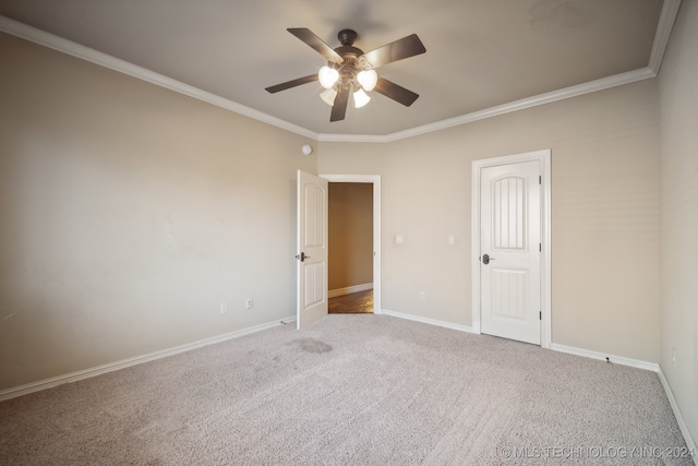 carpeted spare room featuring ornamental molding and ceiling fan