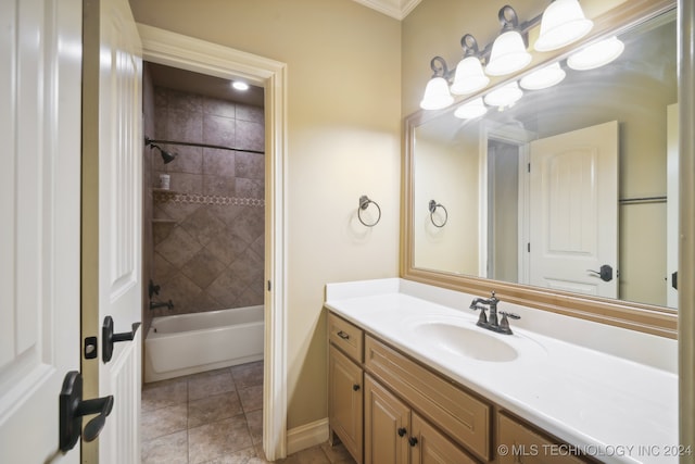 bathroom with ornamental molding, tile patterned floors, tiled shower / bath, and vanity