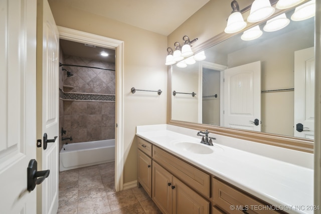 bathroom with tiled shower / bath and vanity