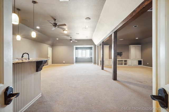 living room with light carpet, vaulted ceiling, ceiling fan, and a textured ceiling