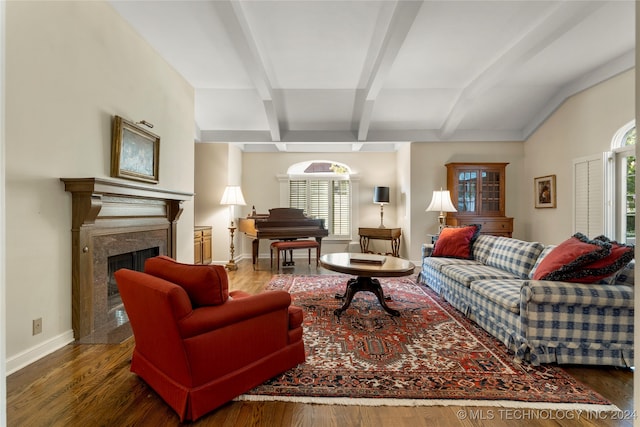 living room with a healthy amount of sunlight, dark hardwood / wood-style floors, and a high end fireplace