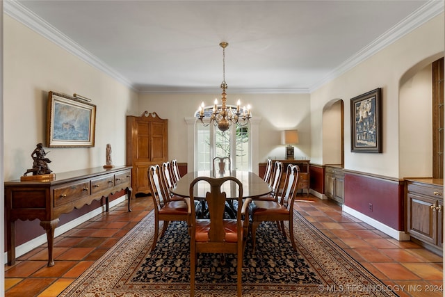 dining area featuring crown molding and an inviting chandelier