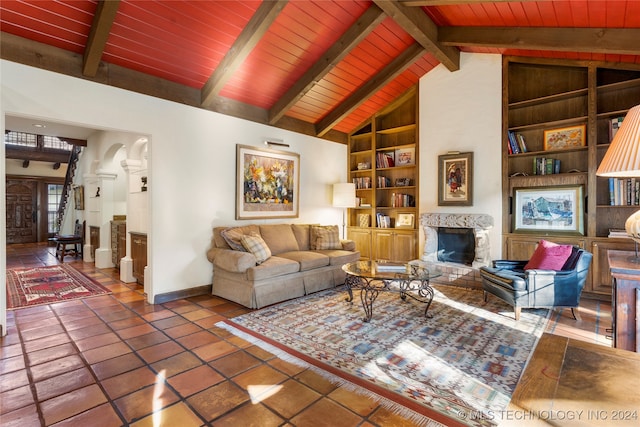 tiled living room with wood ceiling, built in shelves, beamed ceiling, and high vaulted ceiling