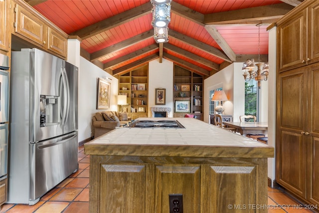 kitchen featuring appliances with stainless steel finishes, a kitchen island, tile countertops, wooden ceiling, and built in features