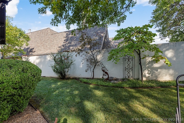 view of property exterior with a lawn