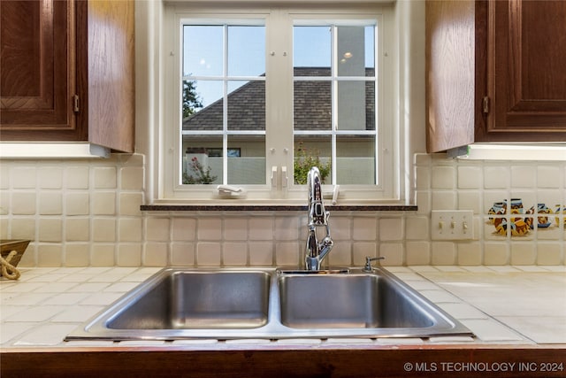 kitchen with tile countertops, sink, and tasteful backsplash