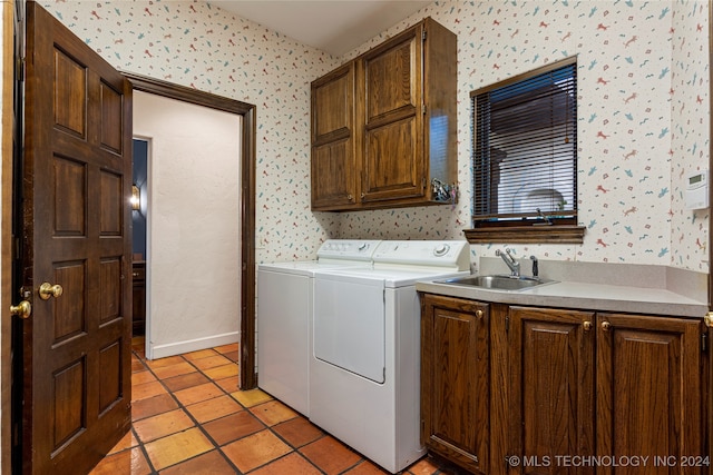 laundry room featuring washer and clothes dryer, cabinets, sink, and light tile patterned flooring