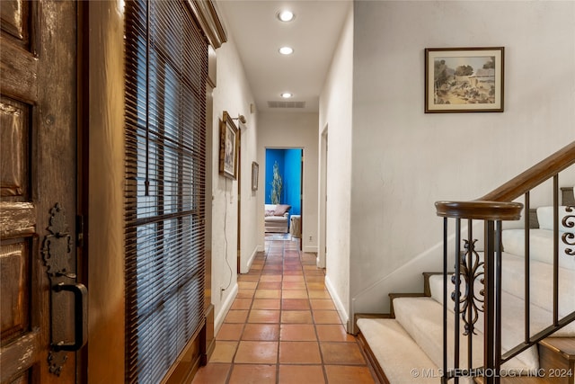 hallway with tile patterned floors