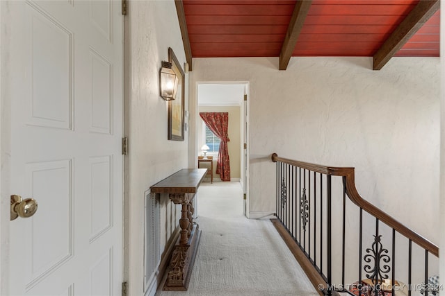 hallway with carpet, wood ceiling, and beam ceiling