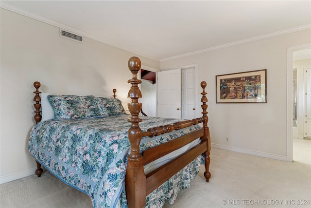 carpeted bedroom with a closet and crown molding