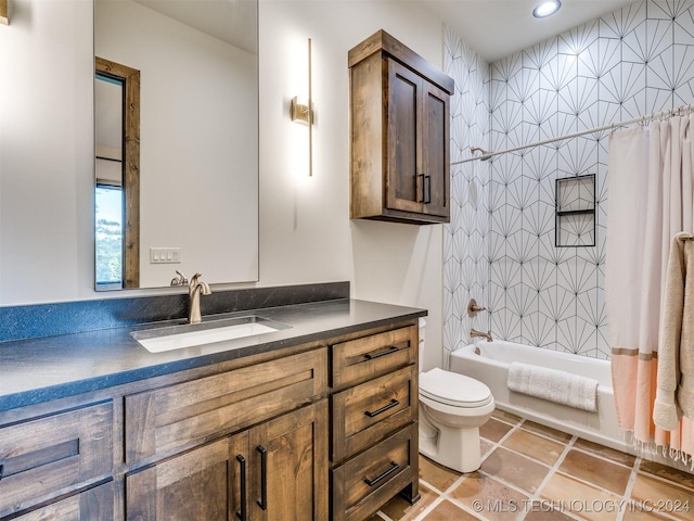 full bathroom with tile patterned floors, shower / bath combo, toilet, and vanity