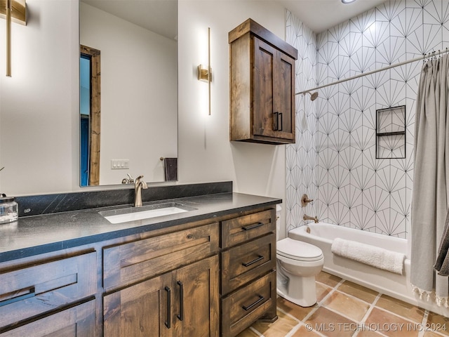 full bathroom with tile patterned flooring, shower / bath combination with curtain, vanity, and toilet