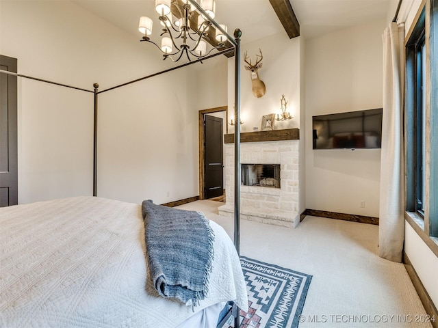 bedroom with light carpet, an inviting chandelier, a stone fireplace, beamed ceiling, and a closet