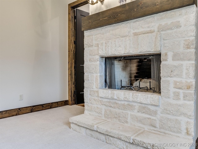 room details featuring a fireplace and carpet