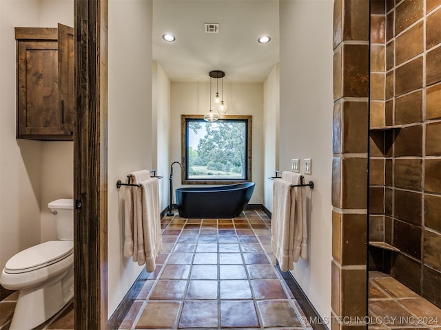 bathroom with walk in shower, tile patterned flooring, and toilet