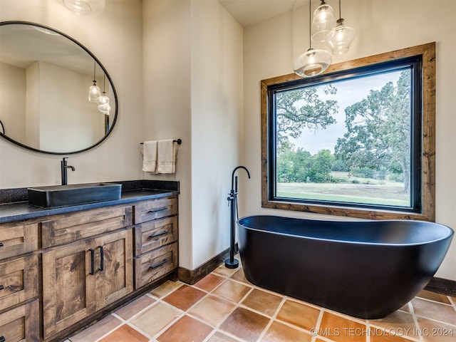 bathroom featuring vanity, a tub to relax in, and tile patterned floors