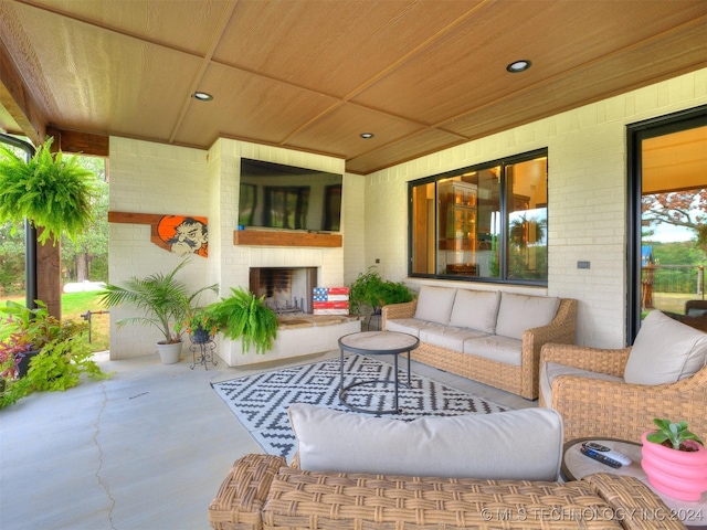 view of patio featuring an outdoor living space with a fireplace