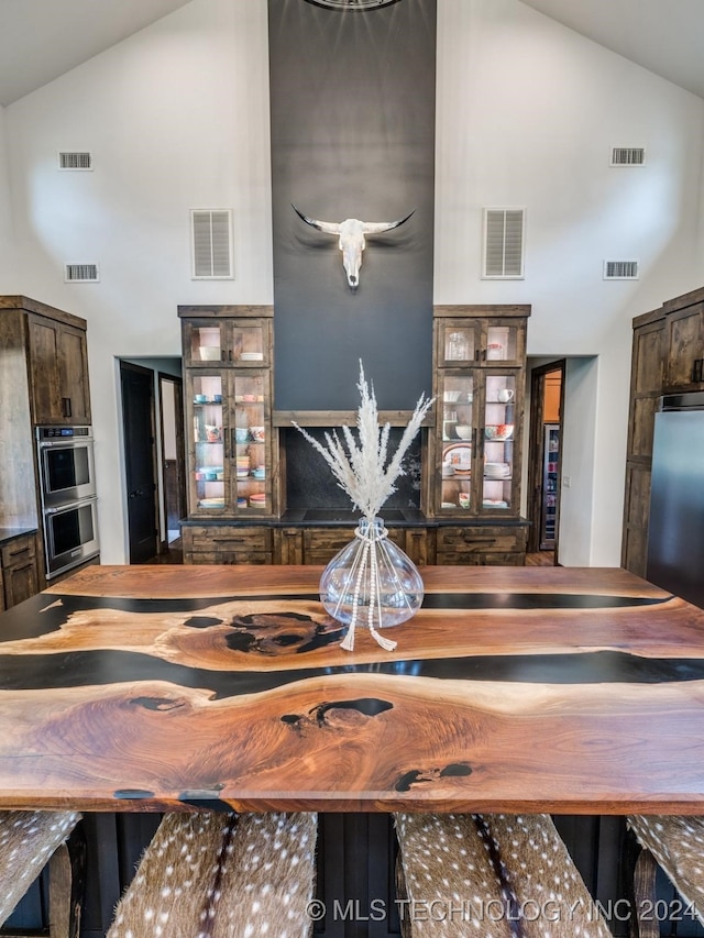 dining area featuring high vaulted ceiling