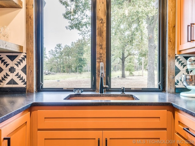 room details featuring decorative backsplash and sink