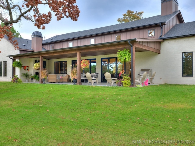 back of property featuring a yard and a patio