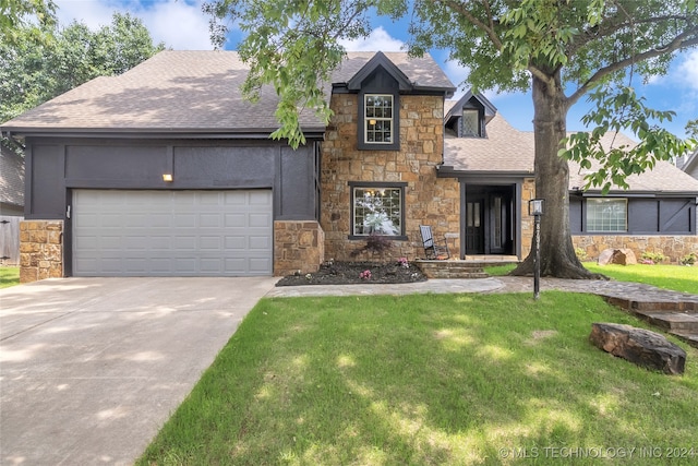 view of front of home with a garage and a front yard