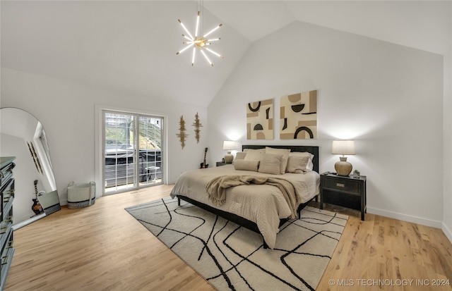 bedroom with high vaulted ceiling, light wood-type flooring, a chandelier, and access to outside