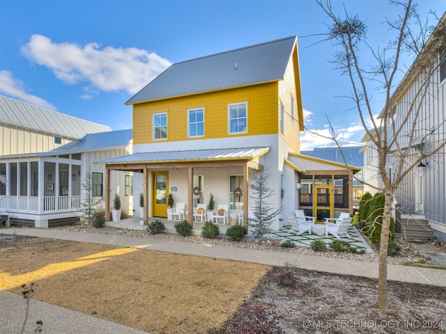 view of front of home featuring a sunroom and a porch