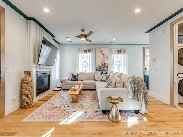 living room with ornamental molding, ceiling fan, and hardwood / wood-style flooring