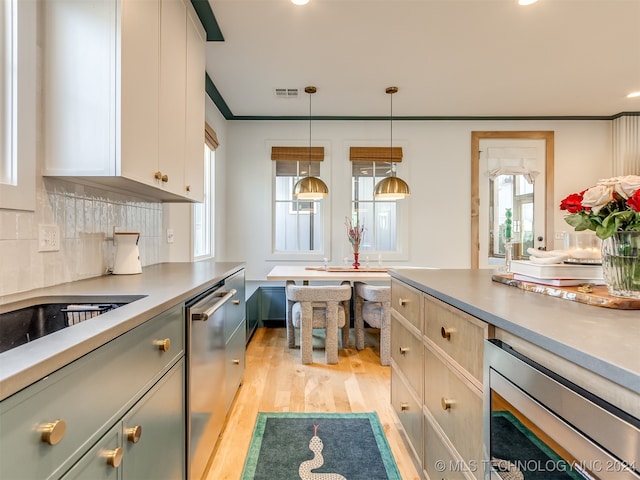 kitchen featuring white cabinets, appliances with stainless steel finishes, light hardwood / wood-style floors, and a healthy amount of sunlight