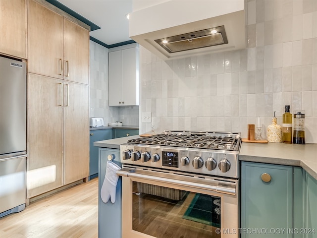 kitchen with ornamental molding, appliances with stainless steel finishes, range hood, light wood-type flooring, and decorative backsplash