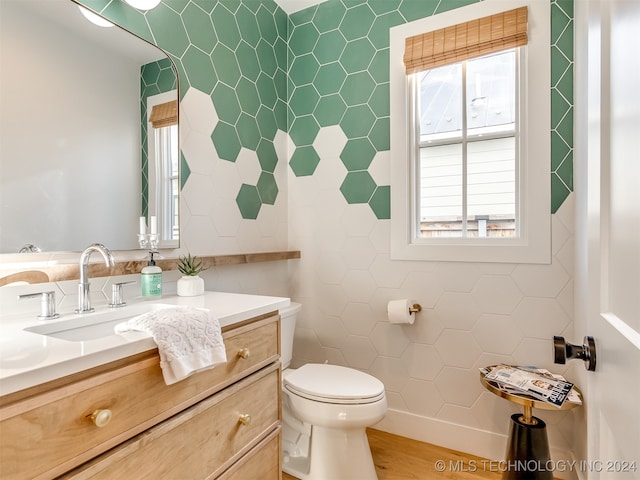 bathroom featuring vanity, toilet, and hardwood / wood-style flooring