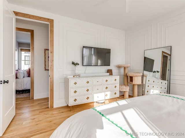 bedroom featuring ceiling fan and light hardwood / wood-style flooring