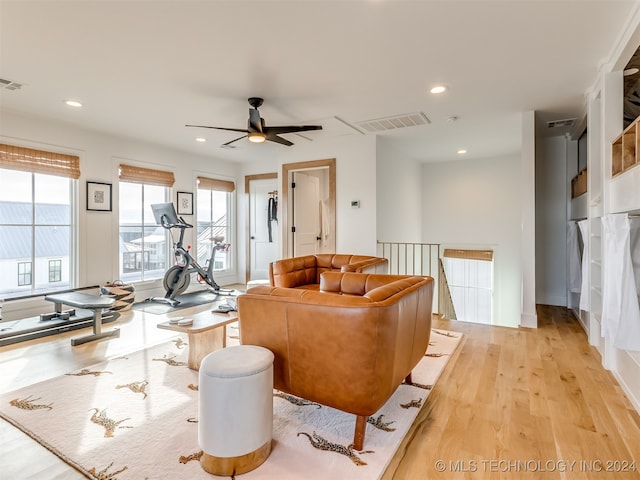 living room with light wood-type flooring and ceiling fan