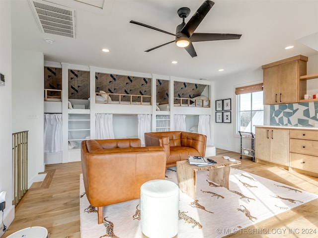 living room featuring ceiling fan and light hardwood / wood-style flooring