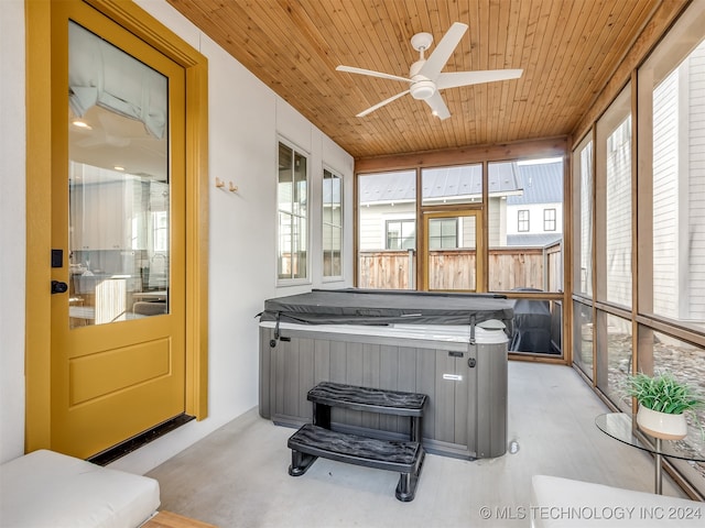 sunroom / solarium featuring wooden ceiling, a hot tub, and ceiling fan