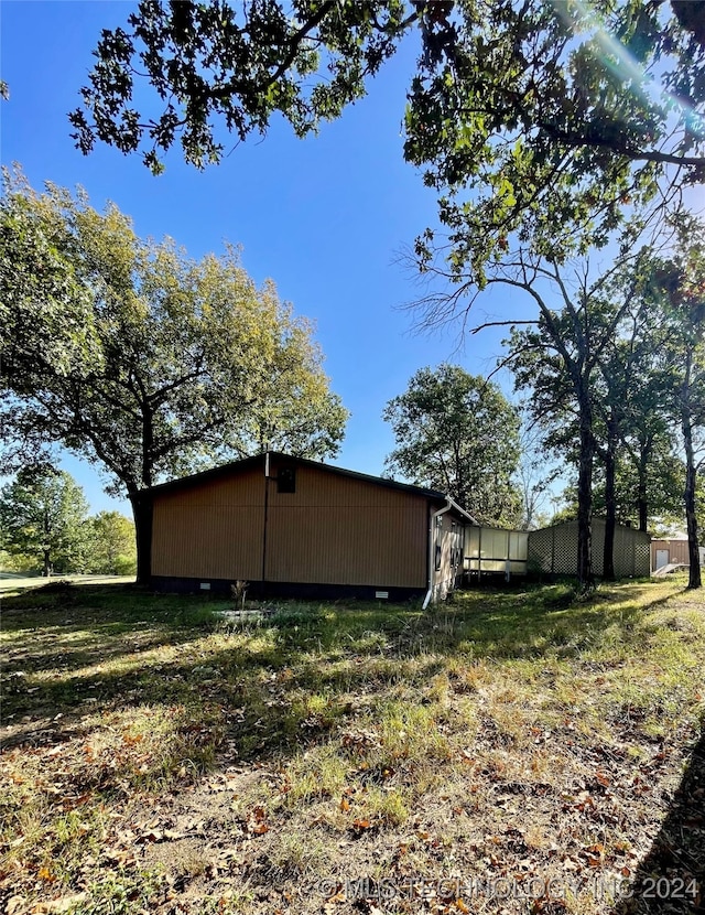 view of side of property with a lawn