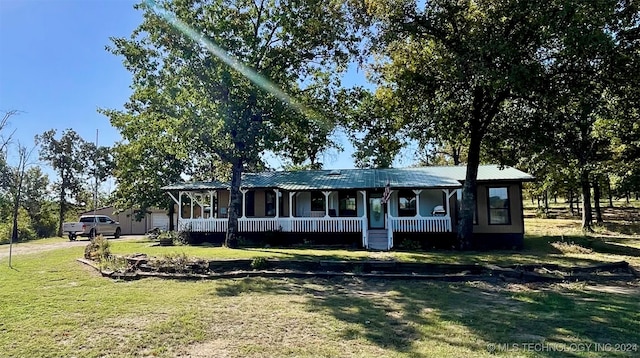 single story home with a porch and a front yard